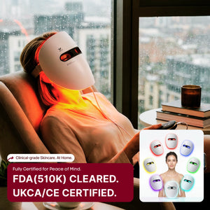 Person using a skincare device labeled FDA cleared and UKCA/CE certified, WAVLO_Apollo_SG_LED_face_mask in a chair with a london cityscape in the background