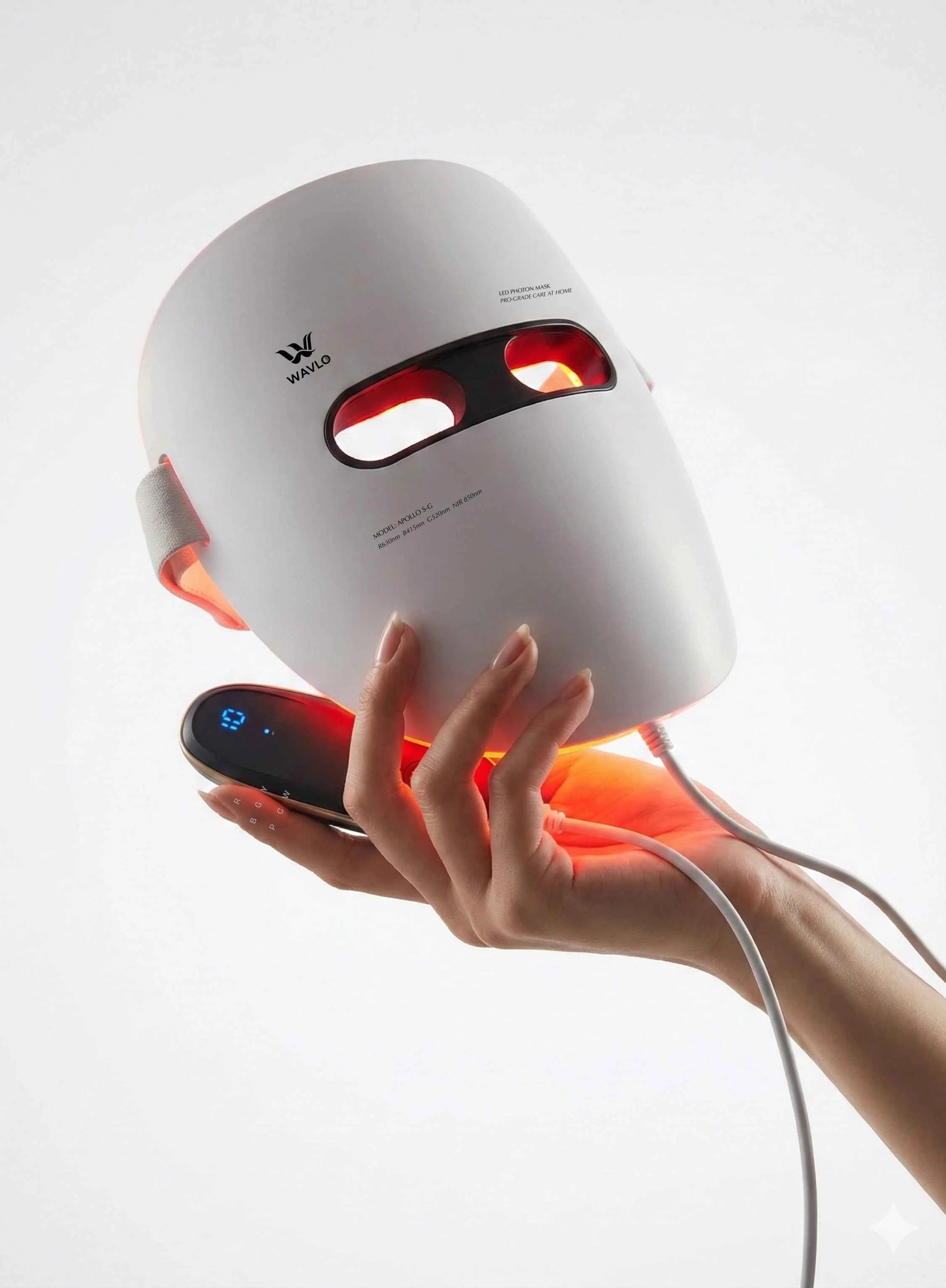 White Apollo SG LED face mask with red lights held by a hand on a white background